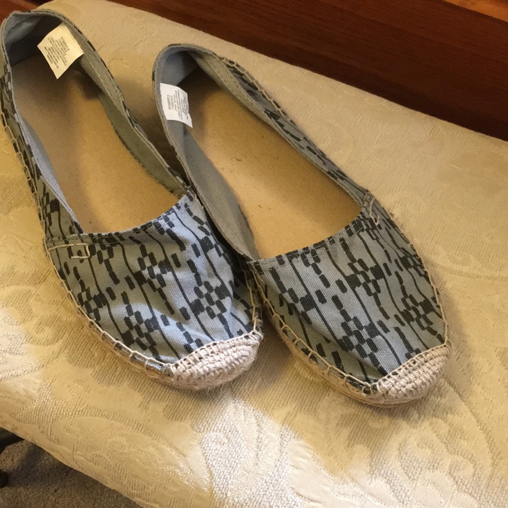 Black and grey women’s flats.
